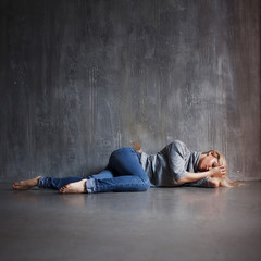 Depression. Young woman lying on the floor