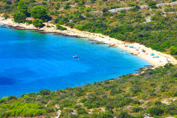 Fototapeta premium Sandy beach and blue sea near Primosten touristic destination in Croatia