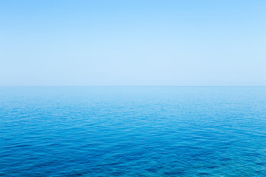 Fototapeta Beautiful seascape without clouds. Perfectly clean smooth sea and clear blue sky
