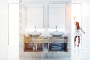 Woman in a white bathroom interior