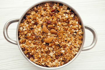 delicious granola muesli with nuts and raising in big bowl, flat lay. healthy breakfast concept. cereal meal flat lay