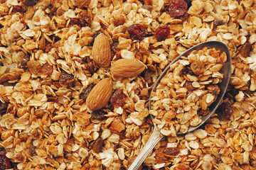 delicious granola muesli with nuts and raising pattern and vintage spoon, flat lay. healthy breakfast concept. cereal meal