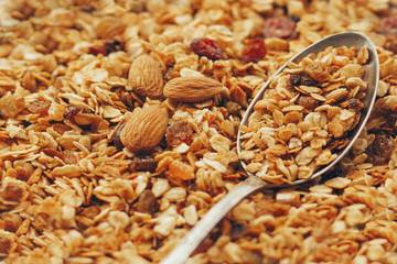 delicious granola muesli with nuts and raising pattern and vintage spoon. healthy breakfast concept. cereal meal top view