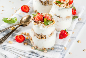Delicious raw ripe persimmon fruit on white marble background copy space