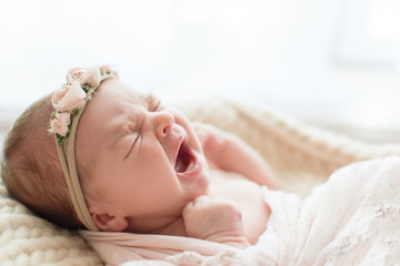 Yawning newborn baby. Photoshoot for the newborn. 7 days from birth. A portrait of a beautiful,...