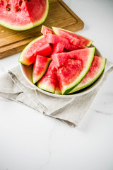 Fresh raw sliced watermelon on light concrete table copy space