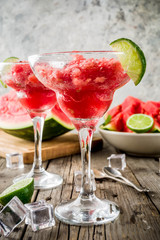 Sweet summer watermelon and lime granita with sliced watermelon and mint, on white marble background copy space