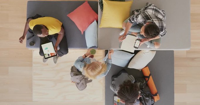 above view group of young multi ethnic college students working together discussing exam project in modern recreational space using mobile technology time lapse