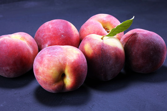 A group of ripe peaches on table