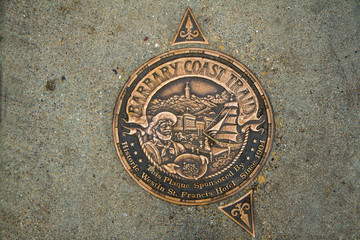 Fototapeta na wymiar Bronze Barbary Coast Trail Marker in a San Francisco Sidewalk