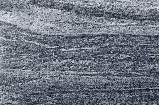 Migmatitic gneiss migmatite rock bands pattern grey light dark banded granite texture macro closeup textured silver gray horizontal background coarse grained feldspar quartz mica minerals gneissic