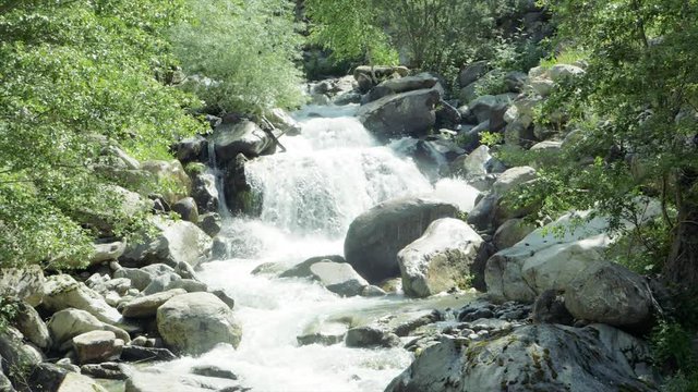 SLOW MOTION Watching a waterfall on a hike in Auron, France.
