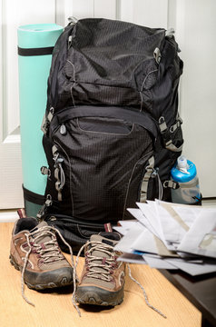 Vacation Is Over (heap Of Mail On The Background Of Tourist's Backpack And Shoes By Entrance Door)