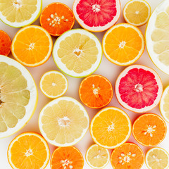 Citrus pattern of lemon, orange, grapefruit, sweetie and pomelo fruits on white background. Flat lay, top view.