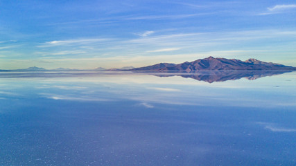 Naklejka na ściany i meble Aerial Uyuni reflections are one of the most amazing things that a photographer can see. Here we can see how the sunrise over an infinite horizon with the Uyuni salt flats making a wonderful mirror. 