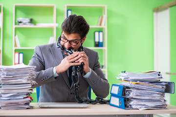 Employee chained to his desk due to workload