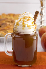 Hot Caramel Apple Cider with an Apple Pie and Cinnamon Stick