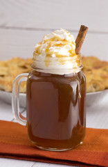Hot Caramel Apple Cider with an Apple Pie and Cinnamon Stick