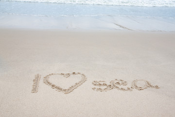 Fototapeta na wymiar Write the word I Love Sea with wave on the beach.