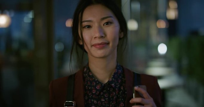 portrait successful young asian business woman student smiling enjoying professional lifestyle beautiful independent female in late urban evening slow motion