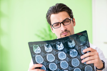 Doctor radiologist looking at x-ray scan in hospital