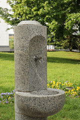 Fototapeta premium Stone drinking fountain in the park