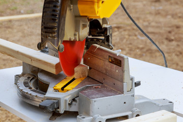 Construction worker remodeling home Carpenter cutting wooden trim board on with circular saw.