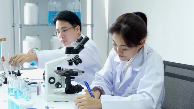 Asian Scientist working together at laboratory. People with medical, science, doctor, healthcare concept. 4K Resolution.