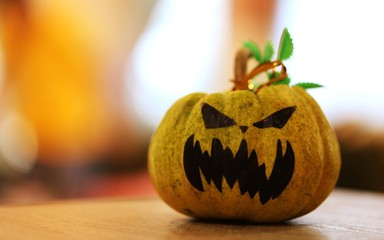 Pumpkin funny face decoration of Halloween's Day closeup blur backgroun