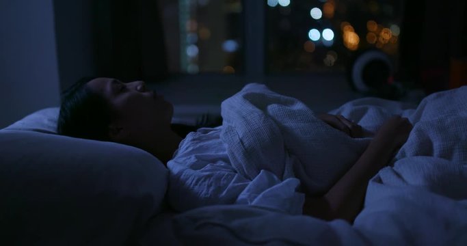 Woman suffer from insomnia on bed at night