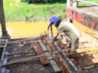 blurred image of group asian laborers working in the construction site for road street repairing and resurfacing works. Fresh asphalt construction.