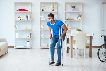 Injured man with crutches recovering at home 