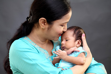 Newborn baby on hands mother 