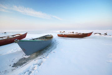 Boat on ice and winter landscape nature composition.