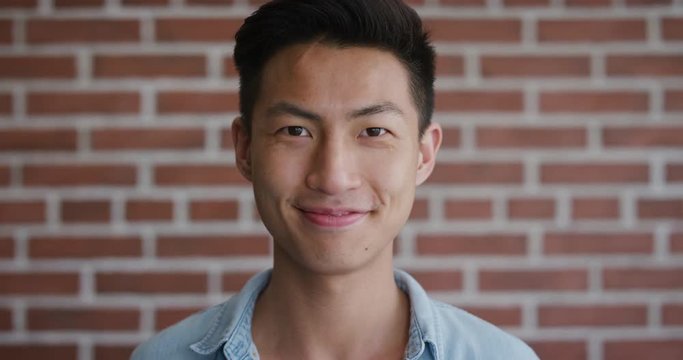 portrait independent young asian man smiling enjoying success looking happy confident male slow motion