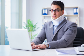 Businessman with neck injury working in the office