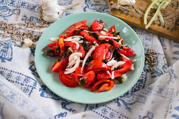 Vegetables salad with tomatoes, wakame seaweed, onion, herbs and spices. Vegan lunch, vegetarian dinner, healthy food.