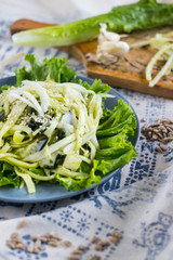 Zucchini spaghetti, raw vegan pasta with avocado sauce and salad leaves on plate. Vegan dinner, vegetarian lunch, healthy food