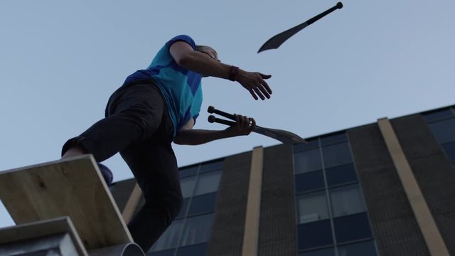 Juggler ends his routine juggling knives