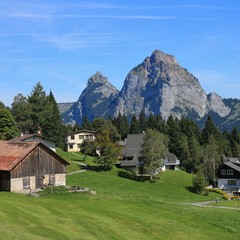 Obraz premium Village Stoss in summer. Mount Kleiner and Mount Grosser Mythen.
