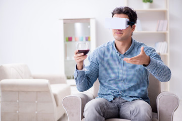 Young man drinking wine at home