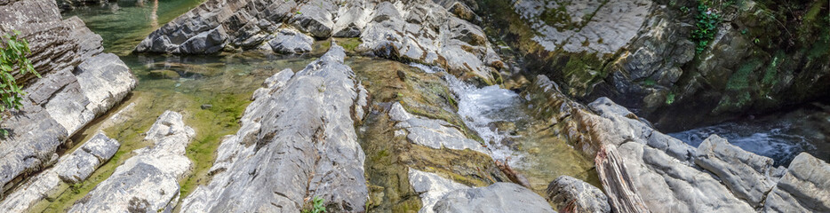 Naklejka na ściany i meble Stone abstract relief in a mountain river.