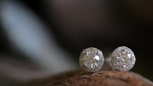 pan down to a pair of studded diamond earrings