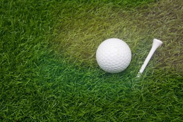Golf ball is on green grass background