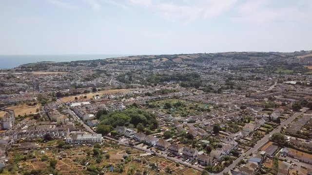 Aerial view of Brixham town in England. Sky view of homes and streets.