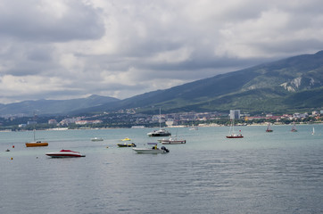 Fototapeta na wymiar Pleasure boats in the sea in the background of mountains.