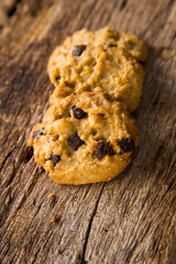 Chocolate chip cookies on rustic wood background.  Sweet biscuits. Homemade pastry