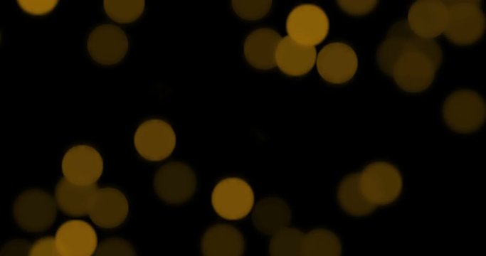 christmas gold gradient sparkle glitter dust particles on black background with bokeh flowing movement, golden holiday happy new year and valentine day love, relationship concept