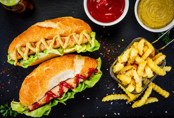 Hot dogs and french fries on cutting board