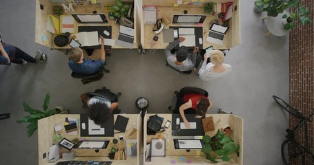 cheerful businessman celebrating success giving colleagues high five enjoying successful teamwork in multi ethnic office workplace top view